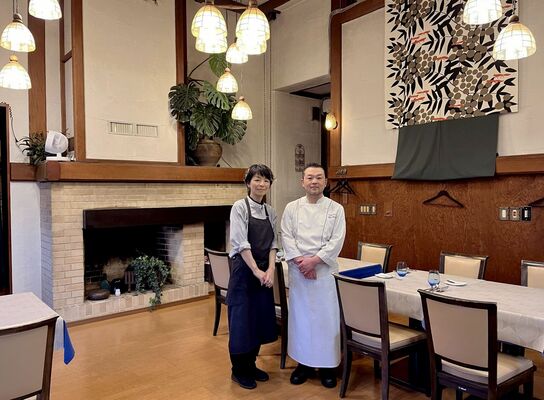 メインダイニングに立つ河又さん夫婦