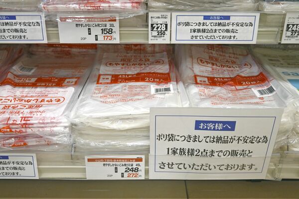 指定ごみ袋について「１家族２点まで」と書かれた札を掲示する小山市内のスーパーの陳列棚