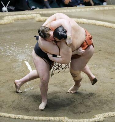 　大相撲初場所千秋楽の優勝決定戦で平幕熱海富士（右）を首投げで破り、２場所連続優勝を果たした大関安青錦＝２５日、東京・両国国技館