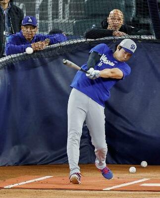 グラウンドで打撃練習するドジャース・大谷。左はロバーツ監督=トロント(共同)