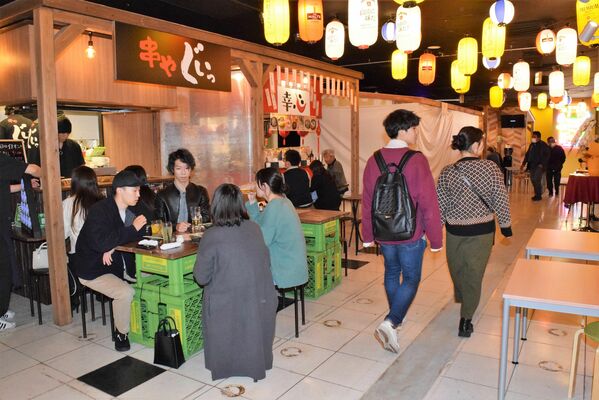 通路の両側に店舗が並ぶ屋内型の屋台村「夜市横丁」＝宇都宮市