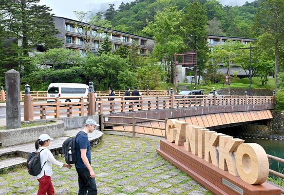 Ｇ７閣僚会合の会場となるホテル「ザ・リッツ・カールトン日光」（奥）の周辺を散策する外国人観光客ら＝23日午後２時30分、日光市中宮祠