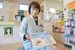 緊急避妊薬の説明書きを手にするミドリ薬局の猪瀬さん＝12月上旬、宇都宮市西川田５丁目