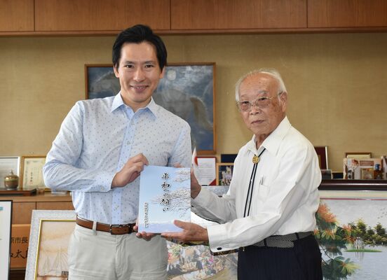 「平和への願い」を渡辺市長に手渡す稲垣会長（右）