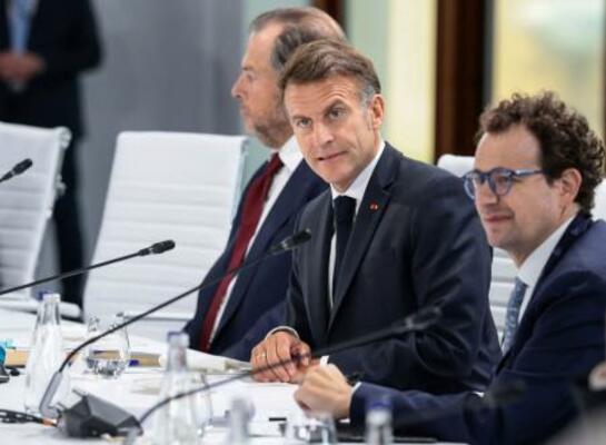米アンソロピックのダリオ・アモデイCEO(手前)とG7サミットの昼食会に臨むフランスのマクロン大統領=17日、フランス東部エビアン(ロイター=共同)