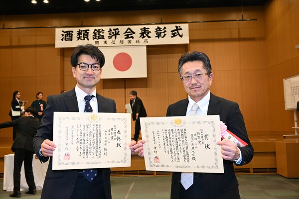 純米吟醸酒の部で受賞した特別賞の賞状を持つ虎屋本店の小堀敦営業部長（右）と表彰状を手にする天満屋徳杜氏＝１３日午後、さいたま市