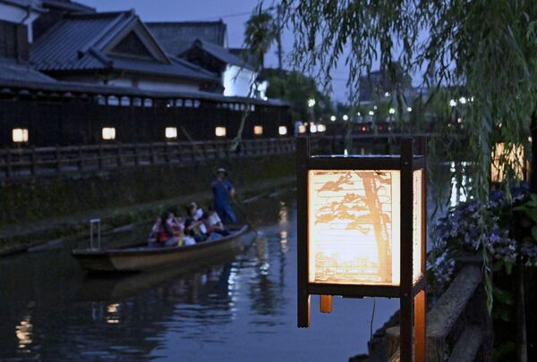 柔らかな光で巴波川沿いを彩るあんどん=1日午後7時5分、栃木市湊町