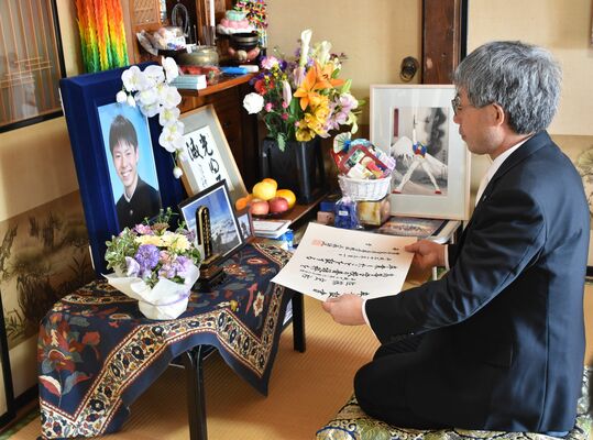 読み上げた卒業証書を佐藤さんの遺影の前に供える三森校長＝２日午前、大田原市狭原