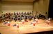 演奏する県警音楽隊とカラーガード隊＝15日午後、県総合文化センター