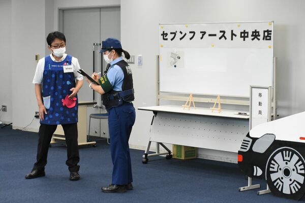 強盗事件を想定し、被害者役（左）から事情聴取する出場者＝14日午後、県警本部
