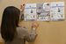 チラシの掲出など準備を進める綾瀬朱里さん（仮名）＝２月下旬、宇都宮市内