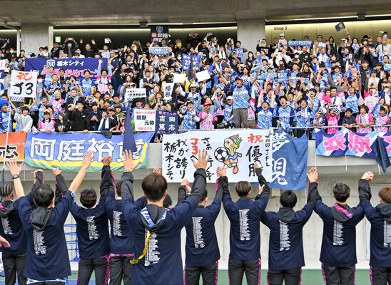 栃木シティのＪＦＬ優勝とＪ３昇格が決まり、選手と喜びを分かち合うサポーターたち＝17日午後、カンセキスタジアムとちぎ、杉浦崇仁撮影
