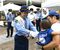 一日警察署長として、来場者に啓発品を手渡す鏡選手＝21日午前、宇都宮市インターパーク４丁目