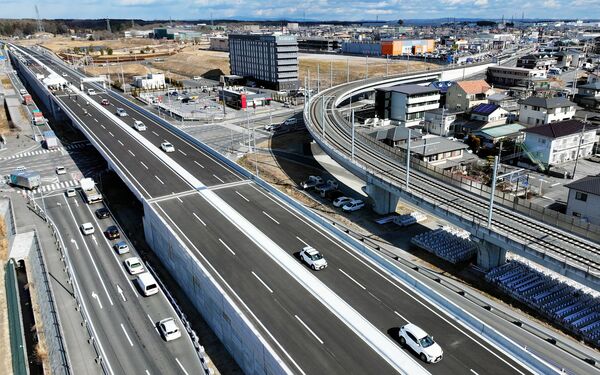 通り初めを行う関係者の車両=30日午前11時35分、宇都宮市野高谷、ドローンから