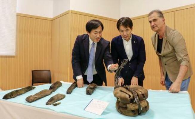 「エルトゥールル号」の遺物を見る(左から)奈良大の今津節生学長、和歌山県串本町の田嶋勝正町長、トルコの水中考古学者トゥファン・トゥランルさん=29日午後、串本町役場