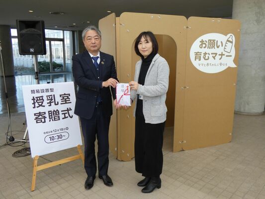 市担当者に目録を手渡す平田支部長（左）