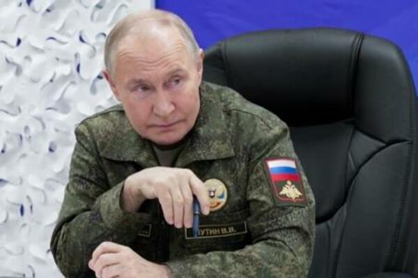 　１１月２０日、ロシア国防省幹部から戦況の報告を受けるプーチン大統領（大統領府提供・タス＝共同）