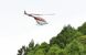 スギ花粉飛散防止剤を散布するヘリコプター＝26日午前、塩谷町上寺島