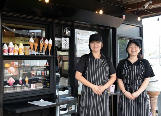 店の前に立つ社員