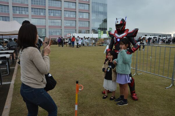最強ラーメン祭会場で来場者と記念撮影するブレイバーン