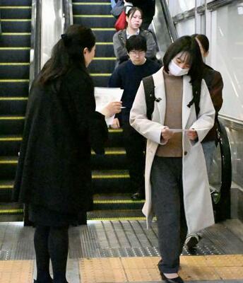 　梶谷恭暉さんの情報提供を求め、ビラを配る母親（左）＝１３日午前、ＪＲ岡山駅前