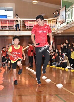 走りながら小学生を指導する桐生選手