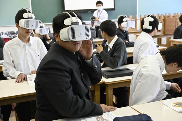 ＶＲゴーグルを着けて農作業事故の映像を見る生徒＝７日正午、真岡市