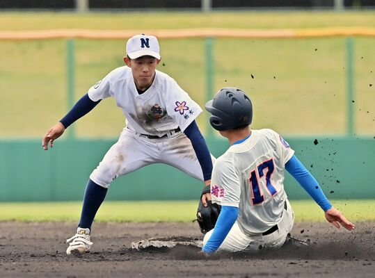 ７回、佐野日大の増山（左）が捕手からの送球を受け、二盗を試みた一走をタッチアウトにする＝富士北麓公園野球場