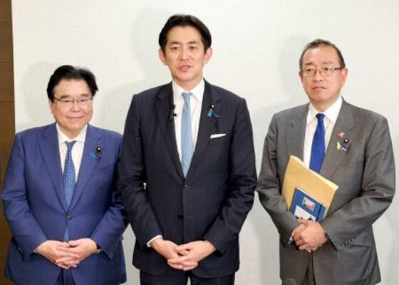 記者団の取材に応じる自民党の小林鷹之政調会長(中央)=5日午後、青森市