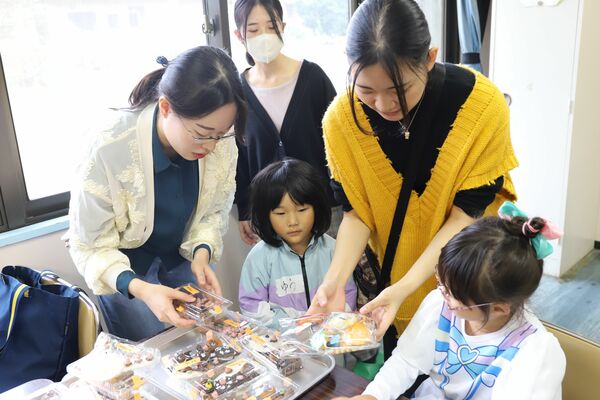 豊永さん(右から2人目)らとお菓子のデコレーション楽しむ子どもたち