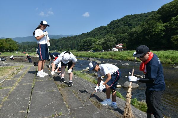 除草作業に汗を流す児童生徒ら