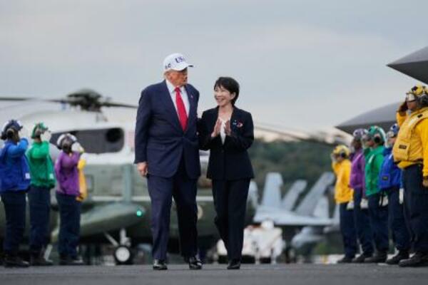 米海軍の原子力空母ジョージ・ワシントンの艦上を歩く高市首相(右)とトランプ米大統領=28日、神奈川県横須賀市(AP=共同)