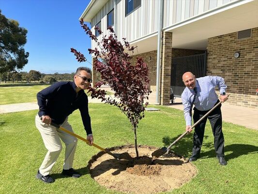 ベニハスモモを植える柳田校長とカミーラ校長（真岡中提供）