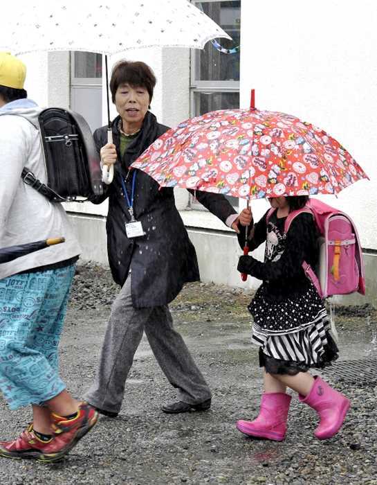 支援のため、小学生のきょうだいを迎えに来た元小学校長の大久保さん。学校との密な連携が信頼関係を深めている=4月下旬、日光市