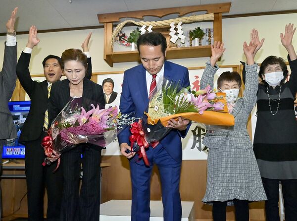 ５選確実の報を受け、頭を下げて支持者に感謝する簗和生氏（中央）＝27日午後10時45分、大田原市末広２丁目