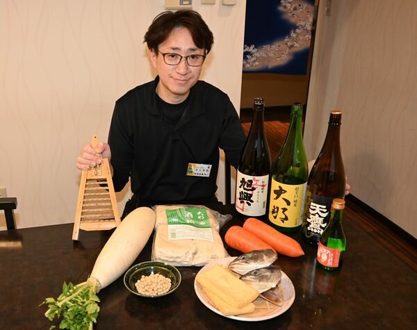 しもつかれの材料やおにおろし、地元の日本酒、しもつかれ酒を紹介する遅沢店長