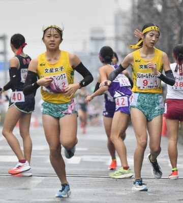 文星女の１区松本（右）が２区長島へたすきをつなぐ＝京都市内、加藤竜矢撮影
