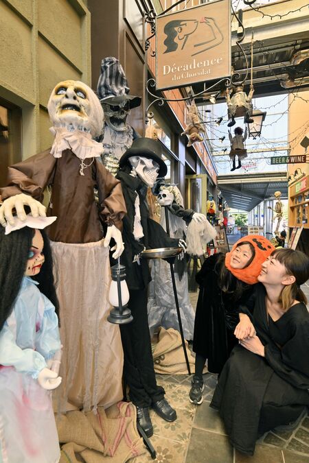本格的なハロウィーン装飾を楽しむ仮装した親子連れ