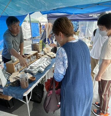 深谷博覧会のブースで紅茶や七味唐辛子をＰＲする松由さん（左）