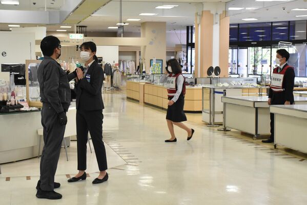 女性店員に詰め寄る犯人役。近くにいた他の女性店員が１１０番した