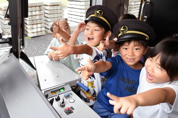 LRTの運転席で「出発進行」と笑顔で声を合わせる園児たち