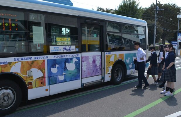 ラッピングバスの出来映えを確認する生徒と早川市長（左）