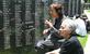 「集団自決」を生き抜いた（左から）大城静子さんと妹の喜久村清子さん。沖縄戦で亡くなった家族が刻銘された「平和の礎」に手を合わせた＝２０２４年６月２３日、沖縄県糸満市摩文仁
