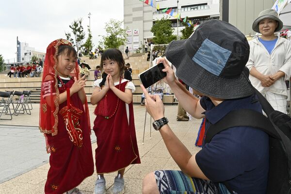 ネパールの民族衣装を着て笑顔を見せる子どもたち＝21日午前、宇都宮市宮みらい