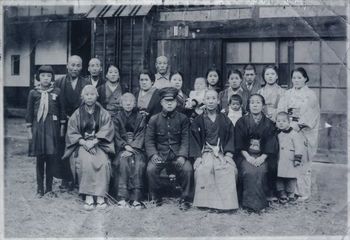 親戚一同と写真に納まる小池秀子さんの次兄正文さん(中央)。長兄の利政さんは戦死した。再び帰れるか分からない出征者は家族と記念撮影をして戦地へ向かった(小池さん提供)