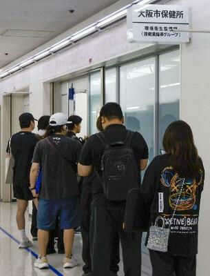 　「特区民泊」の受付会場に並ぶ人＝２９日午前、大阪市中央区
