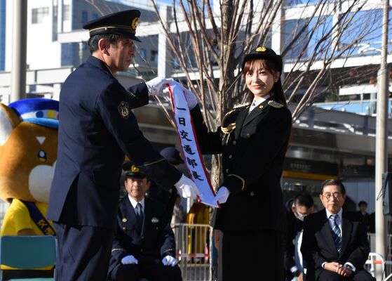 佐藤交通部長（左）から一日交通部長の委嘱を受けた菊池さん＝６日午後、宇都宮市宮みらい