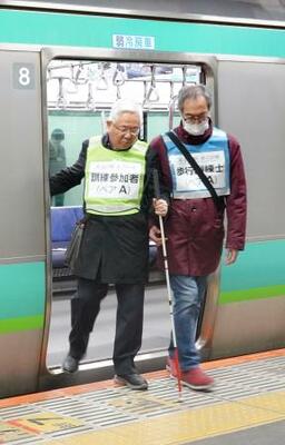 　視覚障害者が安全に電車に乗るための訓練で、白杖を使う参加者＝２日午後、ＪＲ品川駅