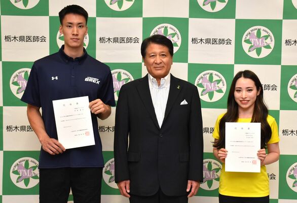 稲野理事長（中央）からサポーターに任命された高島選手（左）とＳＵＭＩＲＥさん＝６日午後、宇都宮市駒生町