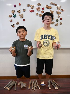 手作りした記念品を紹介する児童代表の青木さん（右）と松下さん